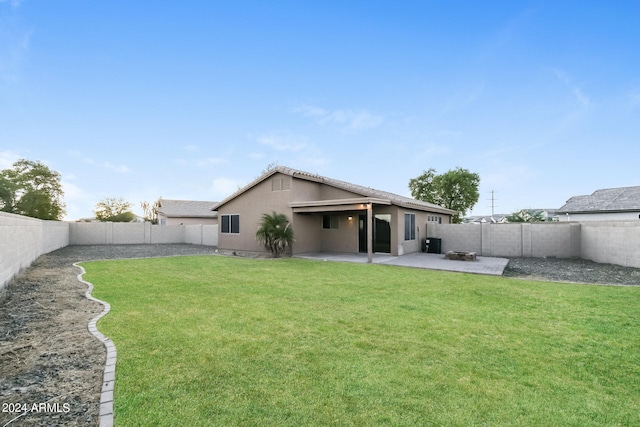 rear view of property with a patio and a yard