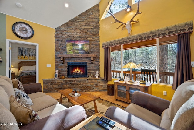3123 S Indian Paint Ln, Pinetop, AZ 85935 - living room featuring wood finished floors, high vaulted ceiling, a stone fireplace, and healthy amount of natural light