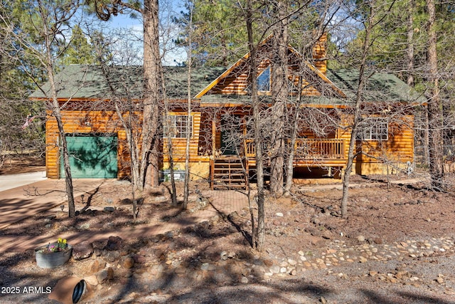 3123 S Indian Paint Ln, Pinetop, AZ 85935 - view of front facade with a wooden deck, log veneer siding, and roof with shingles