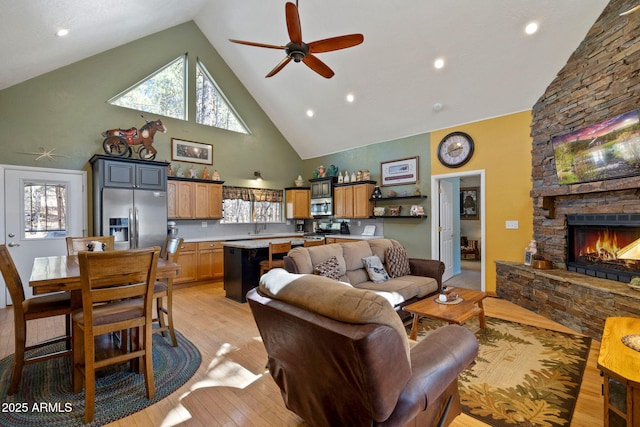 3123 S Indian Paint Ln, Pinetop, AZ 85935 - living room with high vaulted ceiling, ceiling fan, a fireplace, light wood finished floors, and recessed lighting