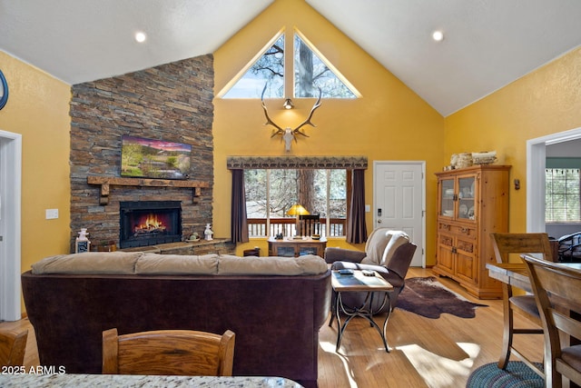 3123 S Indian Paint Ln, Pinetop, AZ 85935 - living area with high vaulted ceiling, a fireplace, and light wood-style flooring