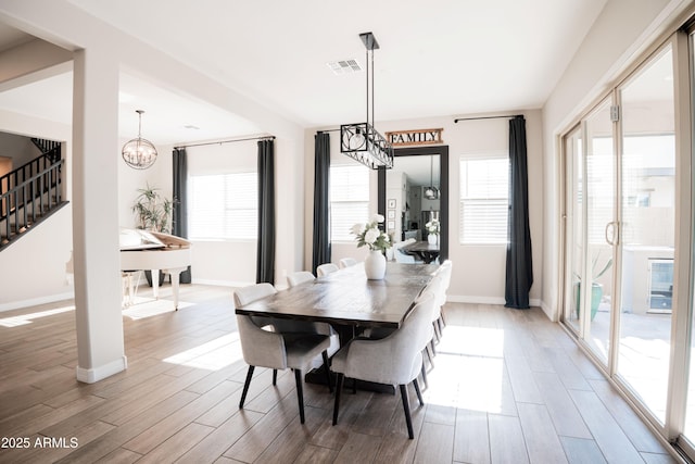 4226 E Coconino Pl, Chandler, AZ 85249 - dining area with stairway, wood finished floors, a chandelier, and baseboards