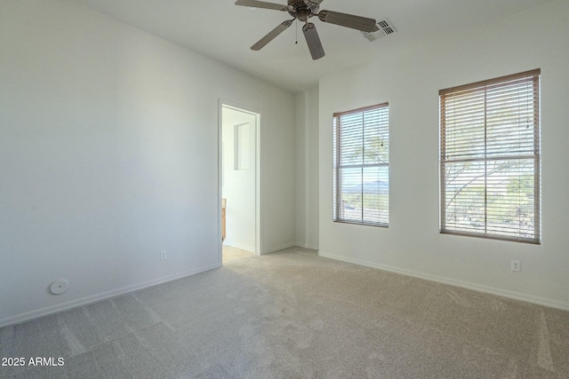 carpeted empty room featuring ceiling fan