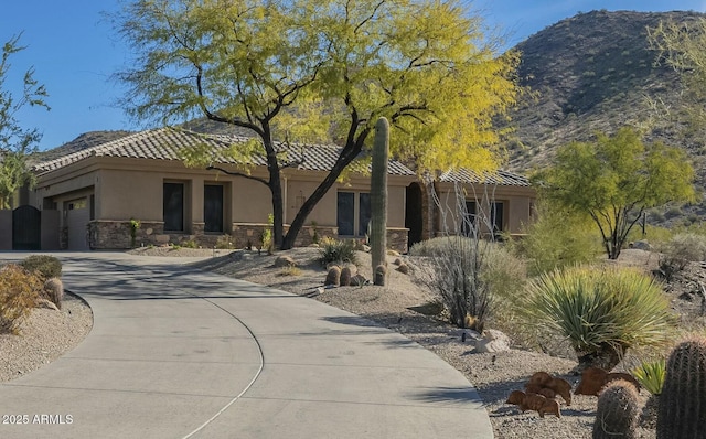 view of front of property with a mountain view and a garage