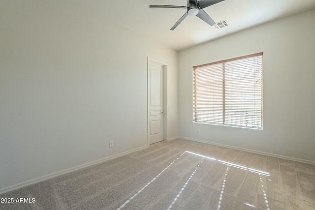 spare room with ceiling fan and light carpet