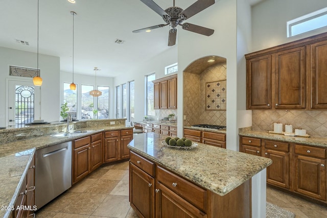 kitchen featuring pendant lighting, appliances with stainless steel finishes, sink, and decorative backsplash