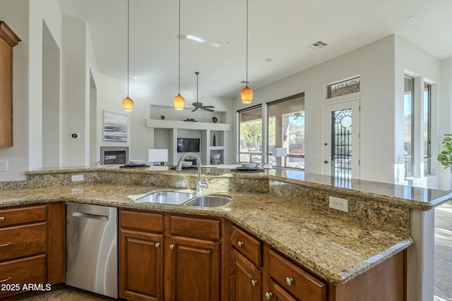 kitchen with light stone counters, sink, and dishwasher