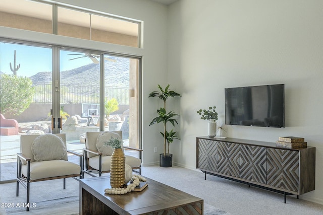 living room featuring a mountain view and light carpet