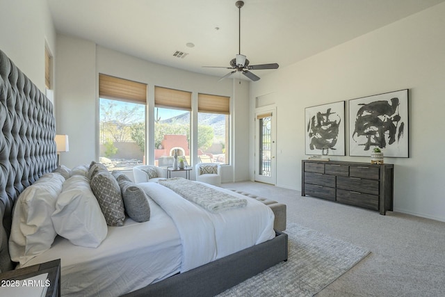 carpeted bedroom with ceiling fan and access to exterior