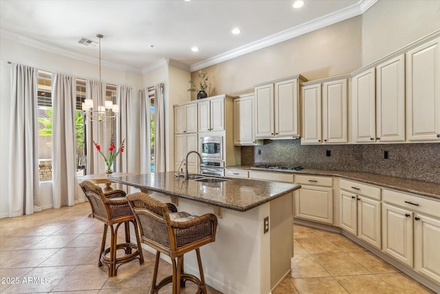 kitchen featuring tasteful backsplash, visible vents, crown molding, stainless steel appliances, and a sink