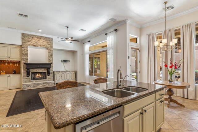 kitchen with visible vents, a sink, a fireplace, and stainless steel dishwasher