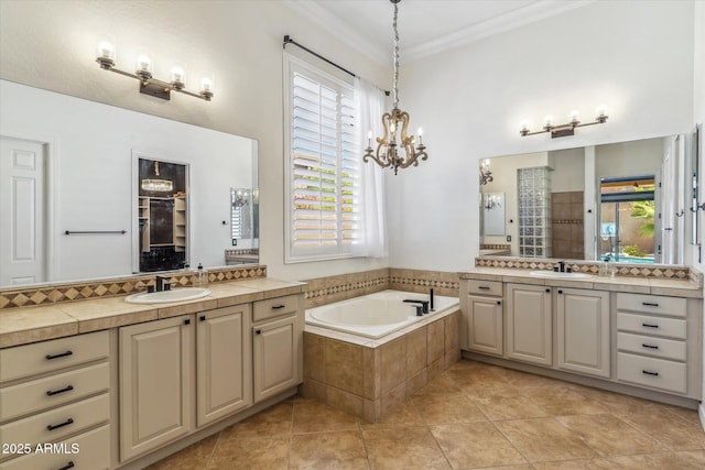 full bath with two vanities, crown molding, a garden tub, and a sink