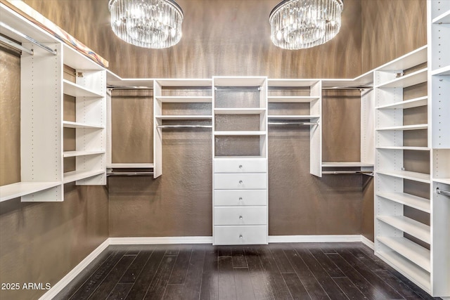 spacious closet with a notable chandelier and wood-type flooring