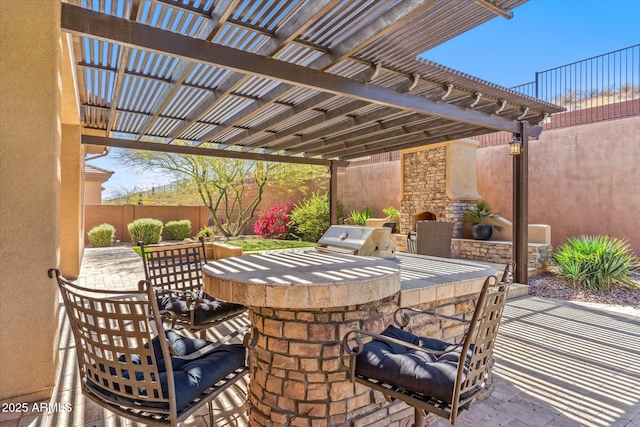 view of patio with a grill, a fenced backyard, a pergola, and an outdoor kitchen