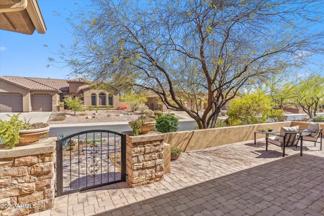 view of patio / terrace featuring a fenced front yard and a gate