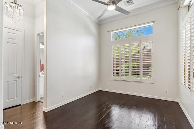 empty room featuring visible vents, ornamental molding, ceiling fan with notable chandelier, dark wood finished floors, and baseboards