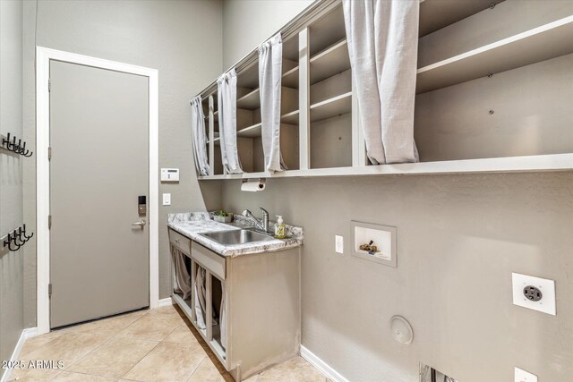 clothes washing area with laundry area, light tile patterned flooring, a sink, washer hookup, and electric dryer hookup