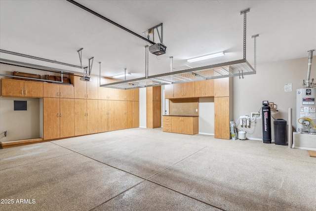 garage featuring water heater and a garage door opener