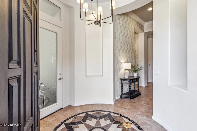 entrance foyer with a chandelier, recessed lighting, baseboards, and ornamental molding