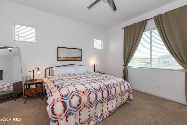 carpeted bedroom with multiple windows and ceiling fan