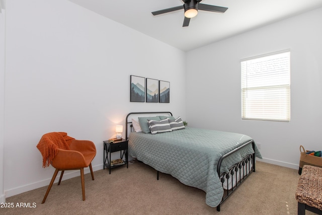 bedroom featuring ceiling fan and light carpet