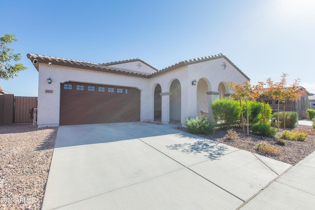 mediterranean / spanish-style house with a garage