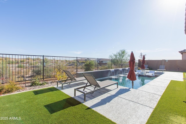 view of pool featuring pool water feature, a lawn, and a patio