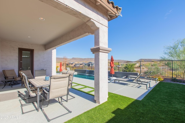 view of patio featuring a fenced in pool and a mountain view