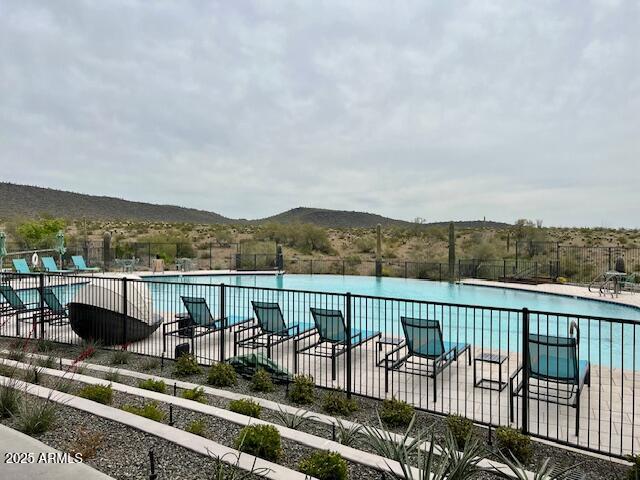 view of pool featuring a mountain view and a patio