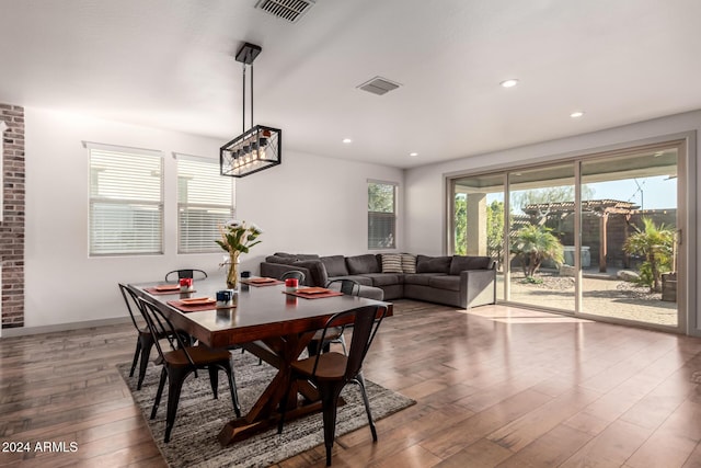 dining space with wood-type flooring