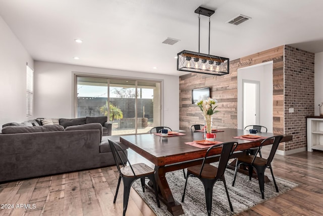 dining room featuring wooden walls and hardwood / wood-style floors