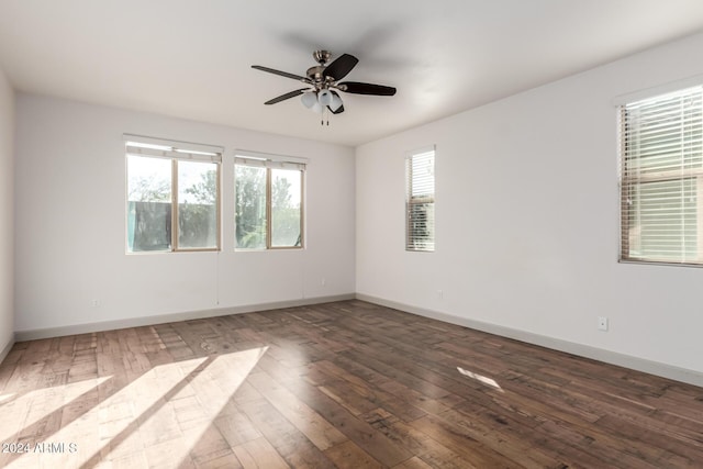 unfurnished room featuring ceiling fan and dark hardwood / wood-style flooring