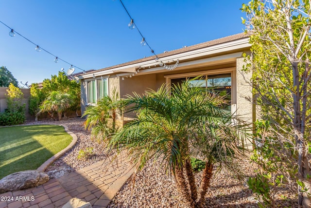 view of side of property with a yard