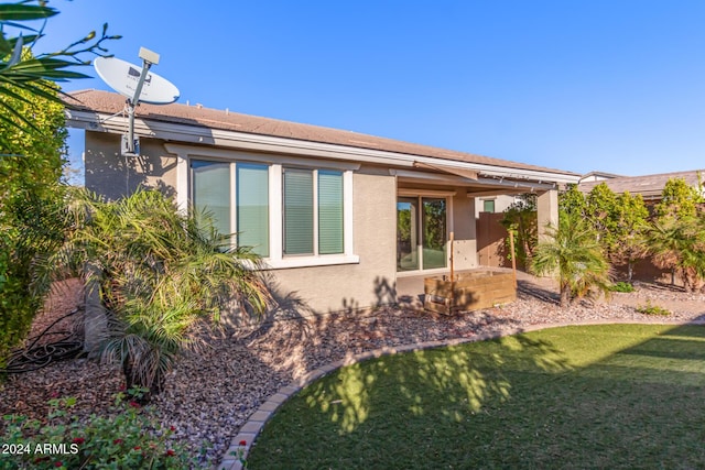 rear view of property with a lawn