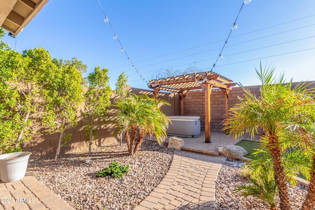 view of yard featuring a pergola and a hot tub