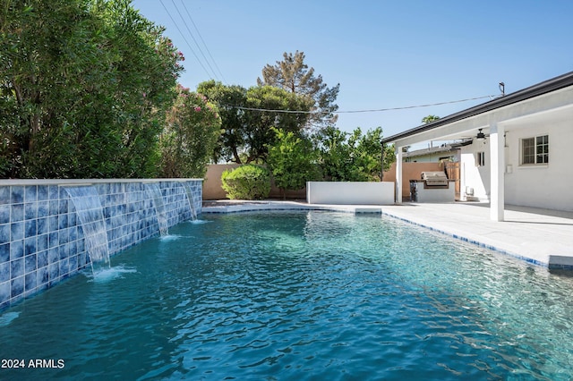 view of pool featuring a patio area, an outdoor kitchen, and a fenced backyard