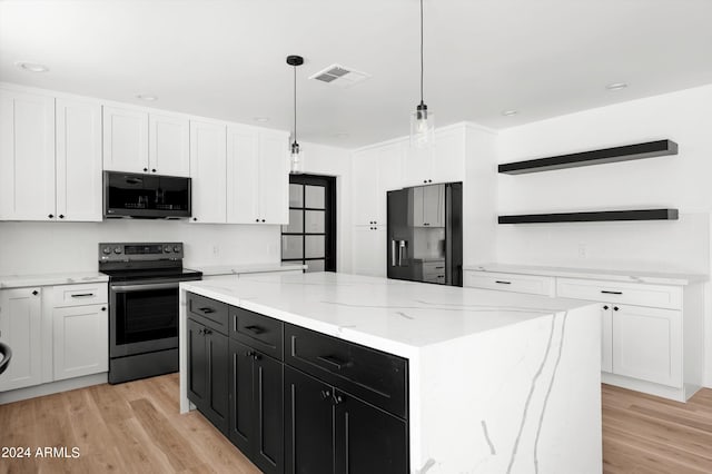 kitchen with electric range, a kitchen island, hanging light fixtures, dark cabinetry, and open shelves