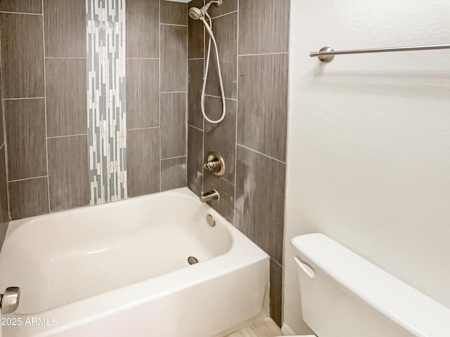 bathroom featuring shower / tub combination and toilet