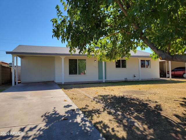 ranch-style home featuring a carport