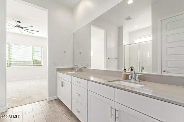 full bath with double vanity, a stall shower, visible vents, and a sink