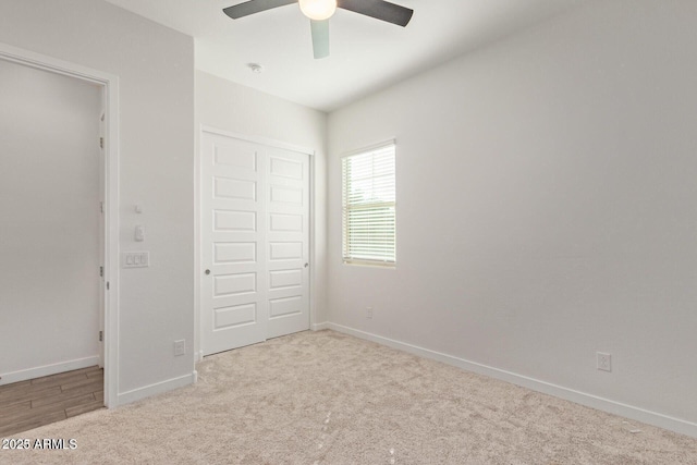 unfurnished bedroom featuring ceiling fan, baseboards, a closet, and carpet flooring