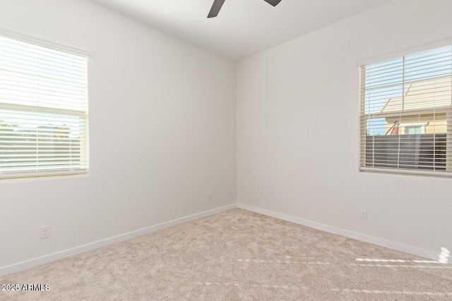 unfurnished room featuring a ceiling fan, baseboards, and carpet flooring