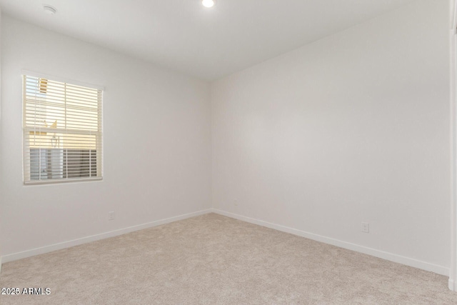 carpeted spare room featuring recessed lighting and baseboards