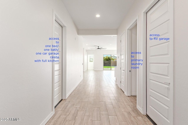 hall with light wood finished floors, baseboards, and recessed lighting