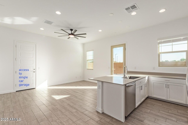 kitchen featuring plenty of natural light, visible vents, and dishwasher