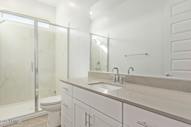 full bathroom with toilet, a marble finish shower, wood finished floors, and vanity