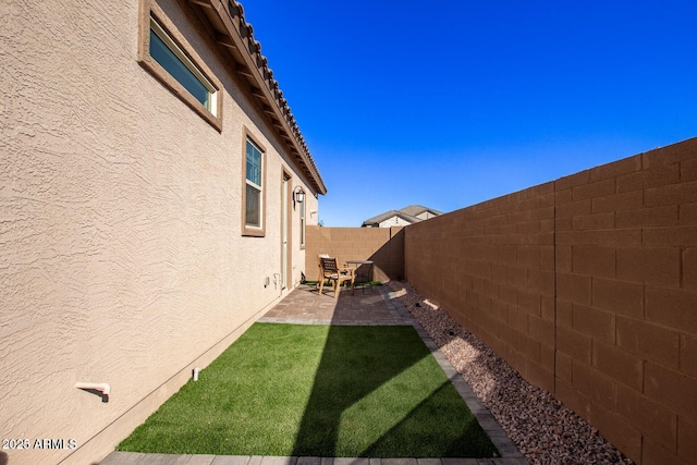 view of yard featuring a patio and a fenced backyard