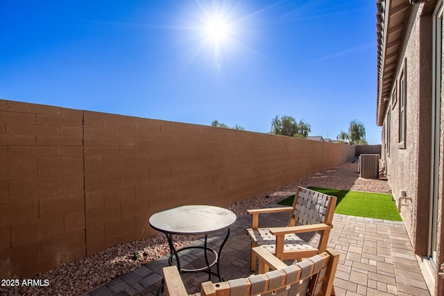 view of patio / terrace with cooling unit and a fenced backyard