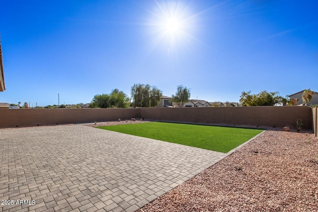 view of yard with a fenced backyard and a patio