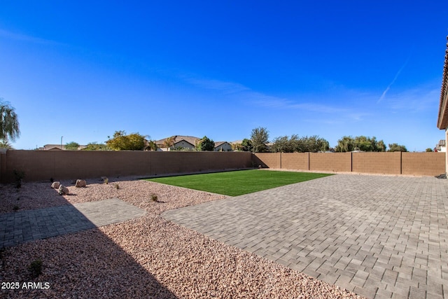 view of yard featuring a fenced backyard and a patio